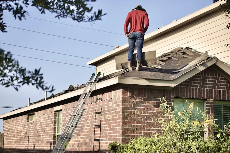 Professional roofer working on a residential roof in San Marino